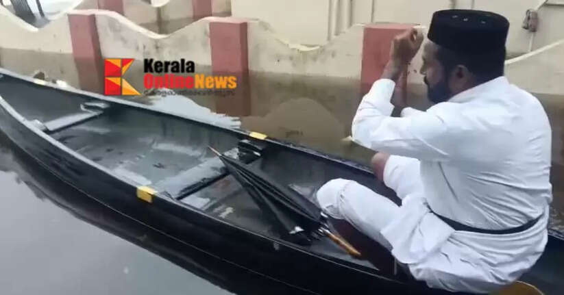 The vicar of the church arrived in a boat to offer evening prayers at a church surrounded by water in Thiruvalla